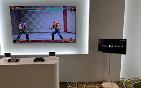 An LG monitor stands next to the wall-mounted screen and table of controllers, showcasing the collaboration between LG, MediaTek and Razer