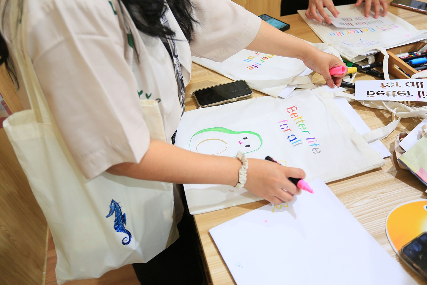 a photo of woman making an eco bag with pink highlighter