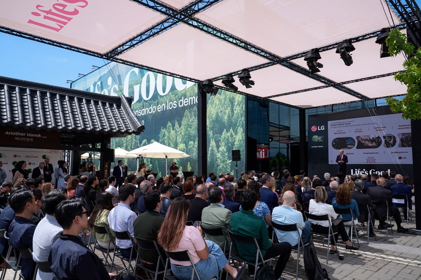 A picture of a crowd of people at the 'Another Hanok' listening to a speaker
