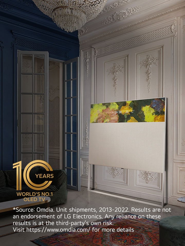 EASEL in Line View leaning against a wall with decorative molding. It sits next to a painting on the wall and behind an intricately designed rug. 10 Year World's No.1 OLED TV emblem.