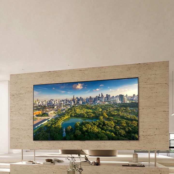 An image of LG OLED evo G3 on the wall of a modern and quirky New York City apartment with a romantic night scene playing on the screen.  10 Year World's No.1 OLED TV emblem. 