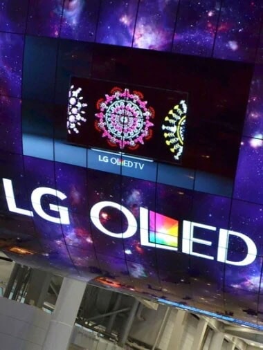 A curved OLED screen installation reading "LG OLED"