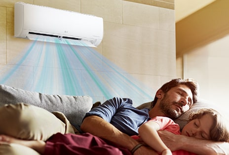 Dad and daughter asleep under the air conditioner.