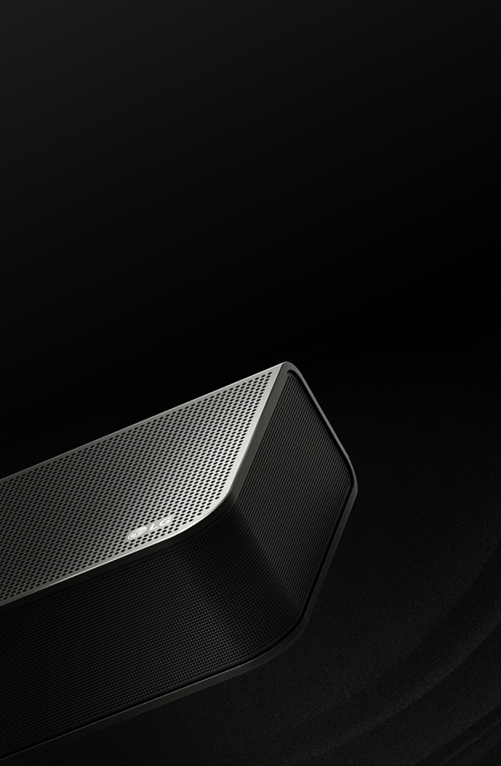 LG Soundbar is against a black backdrop reveals its design starting from the top and moving to the corner. White droplets project from the center and ends of the soundbar like a waterfall, depicting up firing sound.