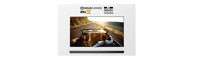 TV and Soundbar together in full view. TV shows a couple in an open roof car on the road driving into the sunset.