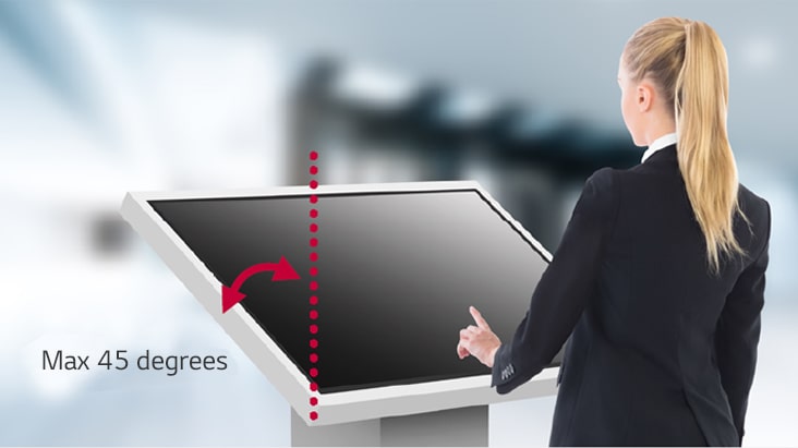 A woman is touching a lower installed TNF5P. The TNF5P is installed tilted toward the woman so she can see the display content well.