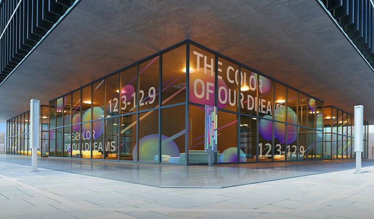 Transparent LED film is installed on the building's first floor glass wall. The content is shown in vivid colors, while at the same time, the part lacking color is transparent, so the inside of the building behind the LED film can be seen.
