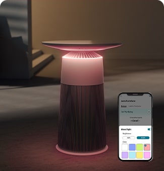 LG smart air purifier with ambient light, positioned in a dimly lit room next to a smartphone displaying control settings.