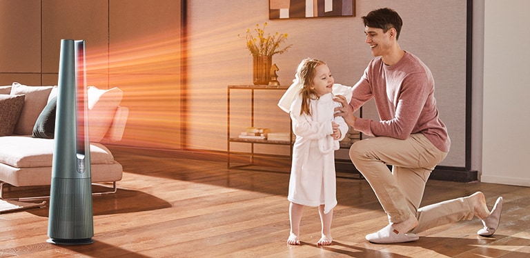 After taking a shower, the child and father are getting warm air in front of the product. Then, when the screen is switched, a woman doing yoga is shown, and a cool breeze is coming out of the product.