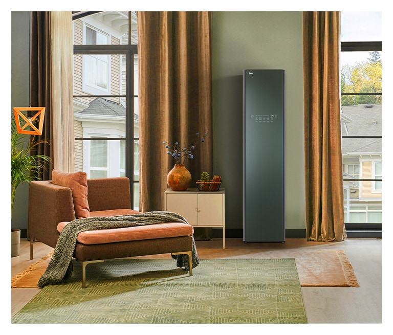 Modern living room with an LG Styler wardrobe by tall windows, a chaise lounge with a blanket, and a side table with a vase.