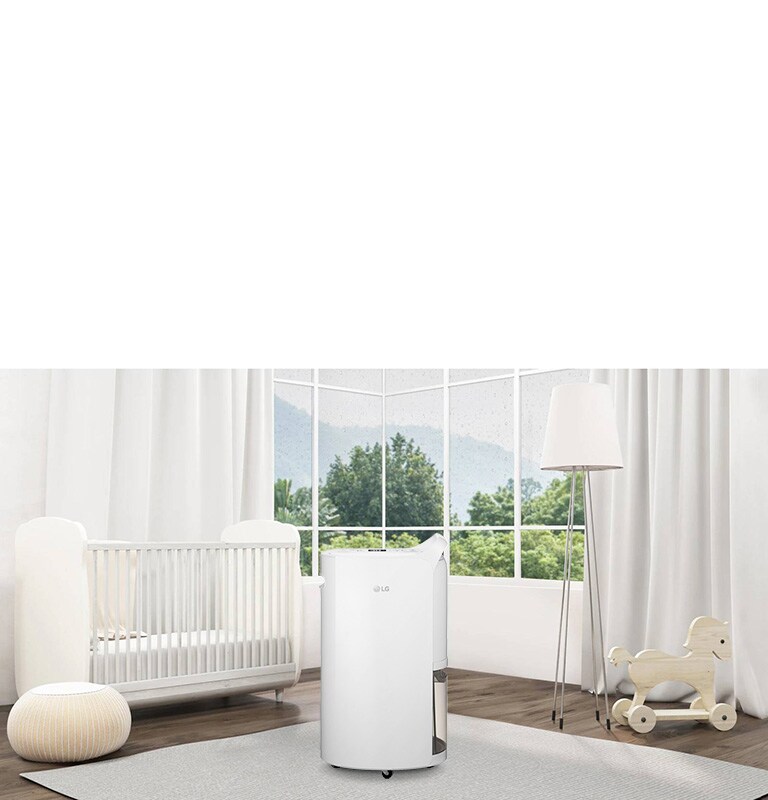 Modern nursery with LG air purifier centered, white crib left, floor lamp and rocking horse right, large windows behind.