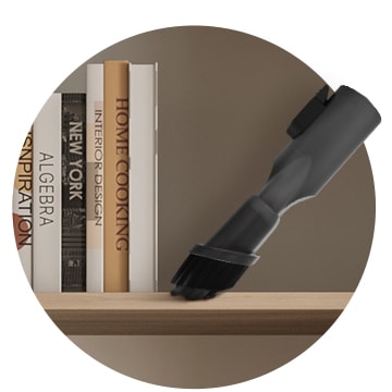 This image shows you using the 2-in-1 Combination Tool to clean narrow gaps such as bookcase gaps, frame gaps, etc.