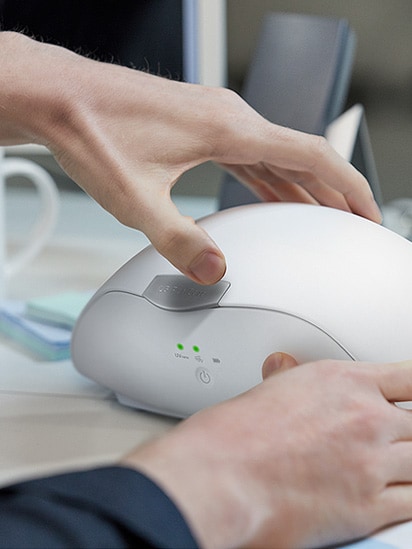 You can see both hands trying to open the PuriCare wearable case.