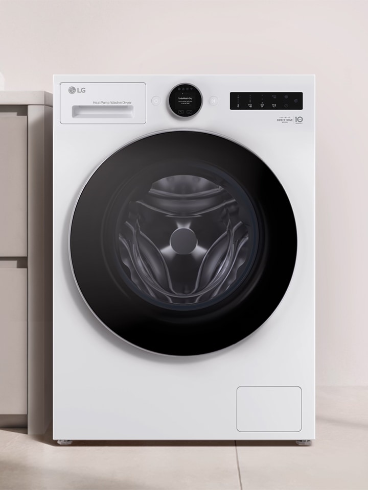 LG white front load washer dryer is placed beside a brown-beige storage cabinet