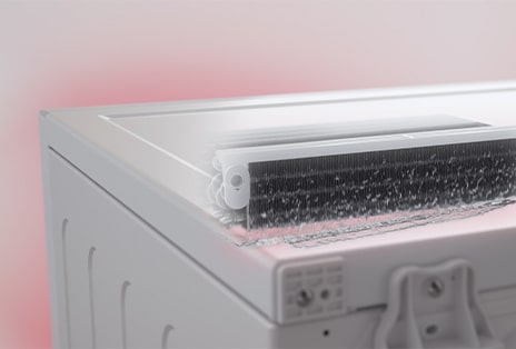 LG white front load washer dryer shows a close-up of the rear condenser with water flowing out.