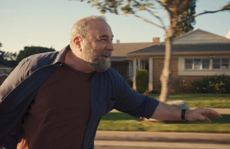 A man skateboarding with a happy expression, demonstrating the power of optimism.