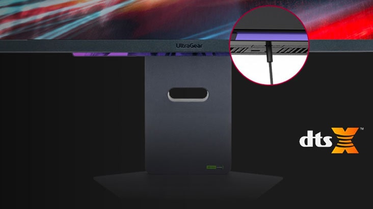It shows the bottom part of the monitor that has a 3-pole headphone port and a headphone cable linked to it.