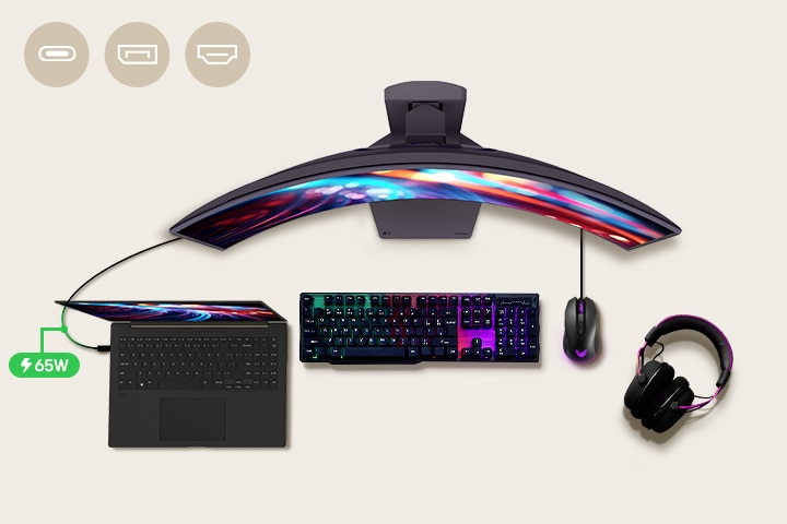 A 34-inch gaming monitor is positioned in the center of the desk, with various IT devices placed around it.