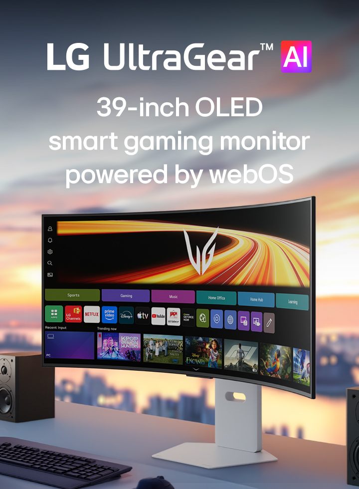 UltraGear™ GX9s OLED gaming monitor displaying the webOS interface on a curved screen, set on a desk with stereo speakers.