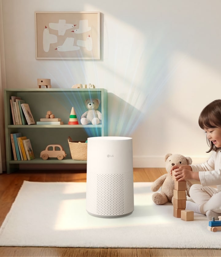A white LG air purifier on a white rug in a nursery, purifying air around a child playing with wooden blocks and various toys on a shelf