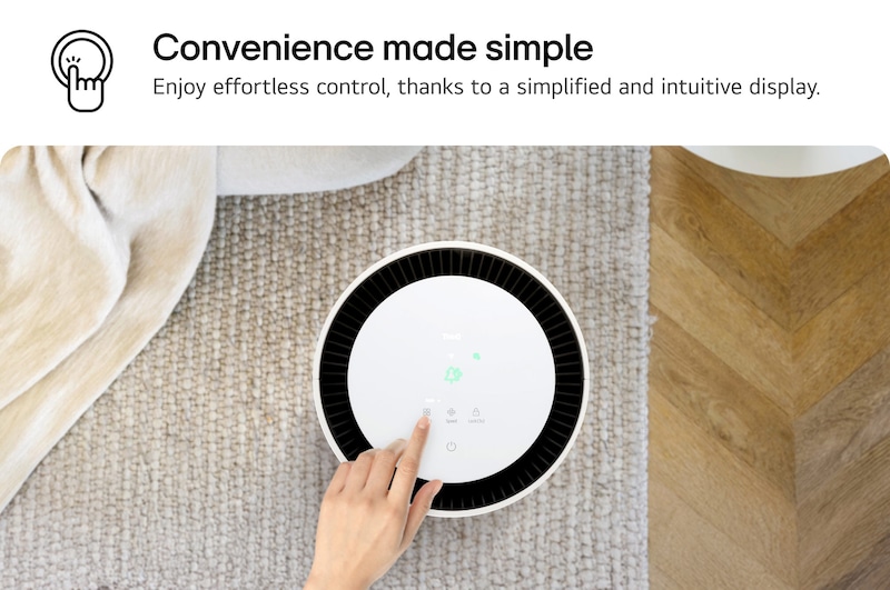 Top view of an LG PuriCare air purifier with a user’s hand interacting with the display, showing icons for settings. Text reads 'Convenience made simple: Enjoy effortless control, thanks to a simplified and intuitive display.'