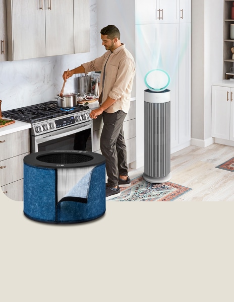 LG air purifier with a cooking filter running in the background as a man cooks in the kitchen.