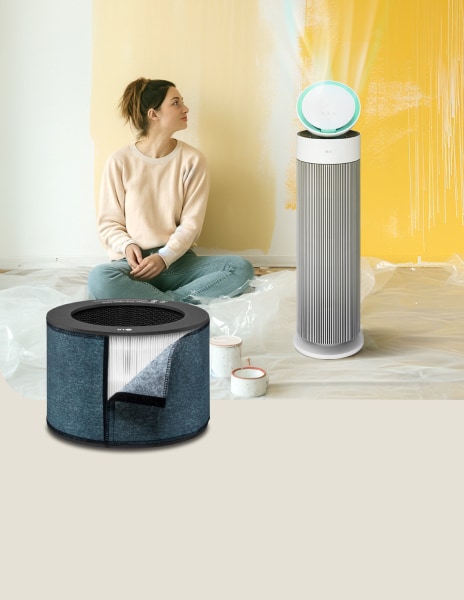 LG air purifier with a formaldehyde filter running next to a woman admiring her paintings in the background.