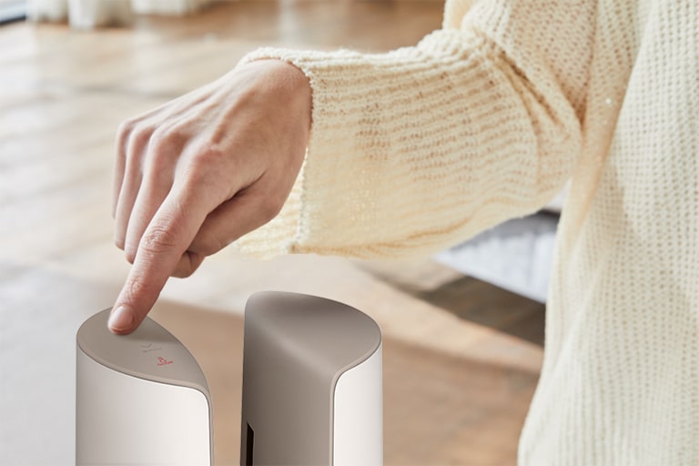 A woman is touching on the top of the product by her finger.