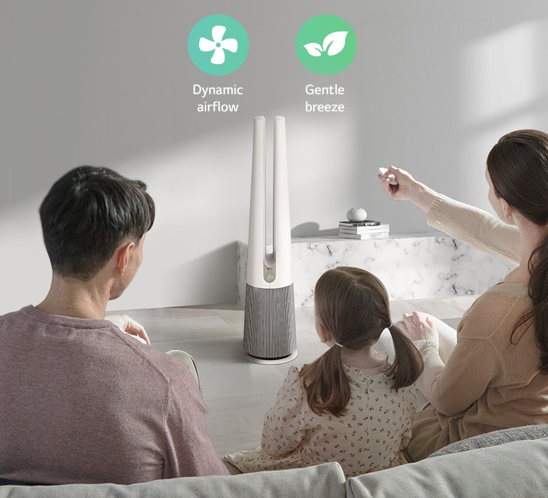 Family enjoying dynamic airflow and gentle breeze from a bladeless fan in a modern living room with marble decor.