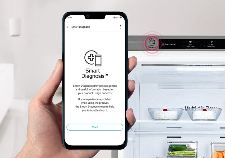 Hand holding smartphone with LG's Smart Diagnosis app near an open fridge, demonstrating the Smart Diagnosis feature.