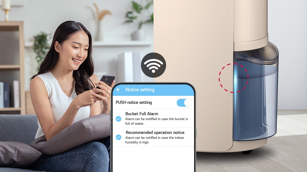 The woman is looking at her phone, the dehumidifier tank is full and the lights are on.