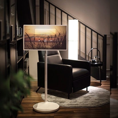 StanbyME is placed in a cozy living room space. Music is playing on the screen.