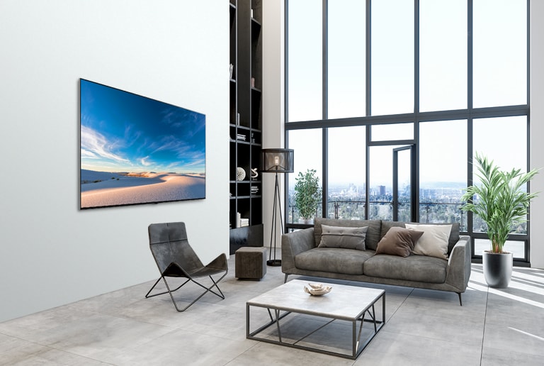 LG QNED TV mounted flat against the wall in a modern interior space.