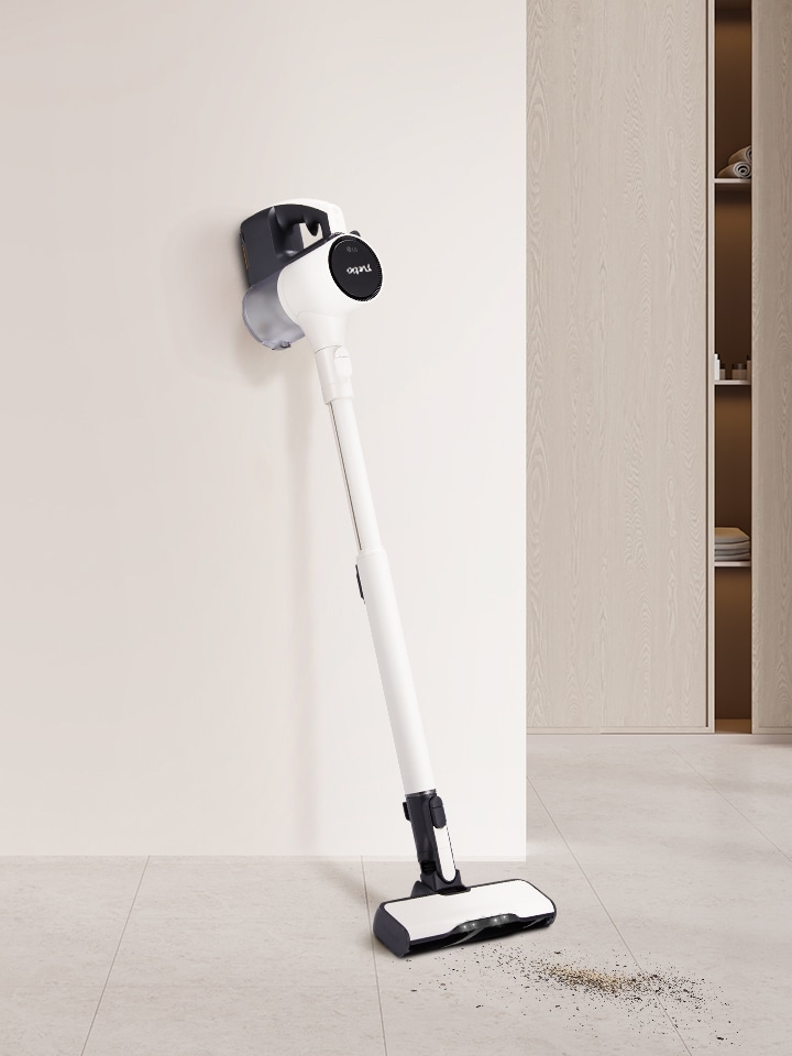 Stick vacuum leaning against the wall.
