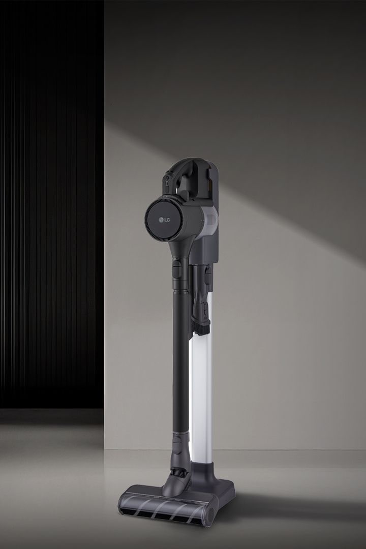  LG a9k-legend3 vacuum standing upright on sleek dark floor with modern background lighting.	