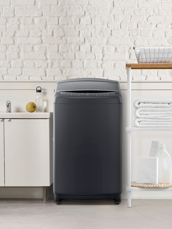 LG top load washing machine in a space with a sink and laundry supplies.	