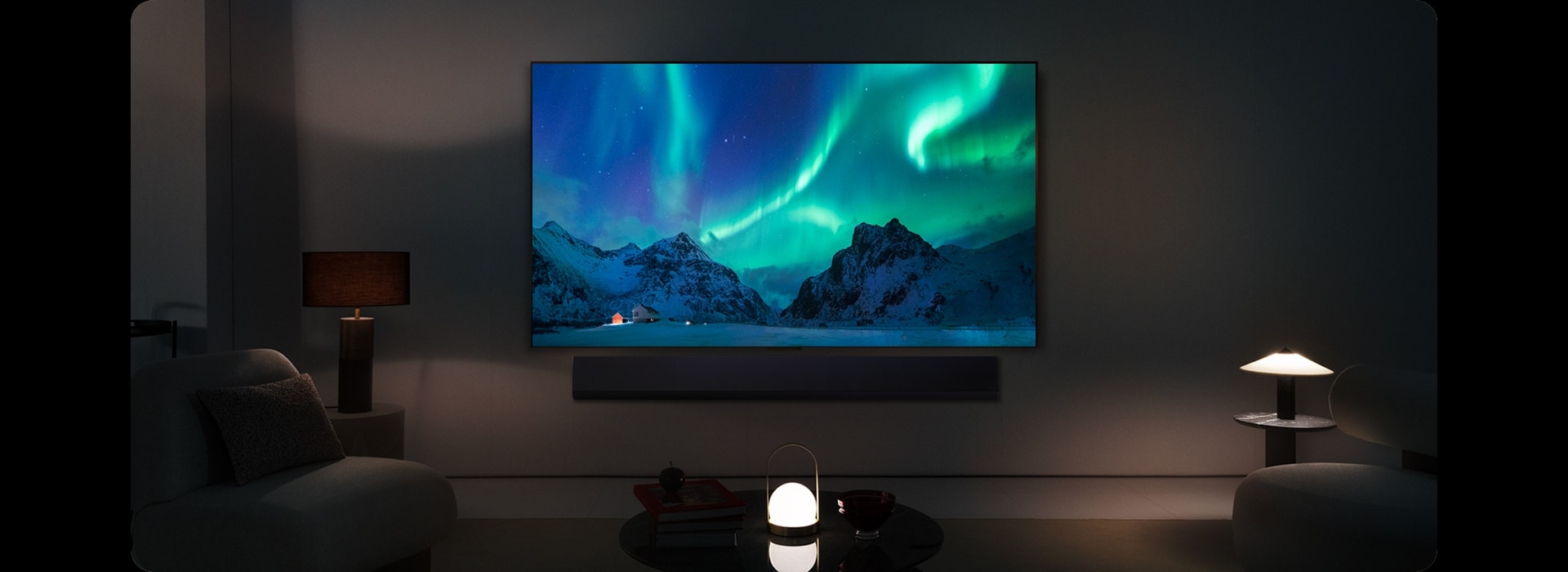 LG OLED TV and LG Soundbar in a modern living space in nighttime. The screen image of the aurora borealis is displayed with the ideal brightness levels.