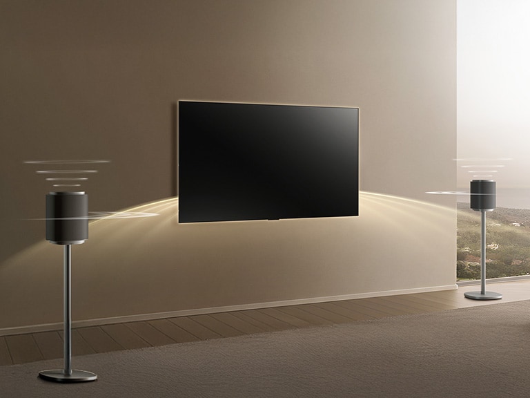 LG complete home theater system with Sound Suite speakers on both sides of the TV, emitting sound waves across the room for full Dolby Atmos