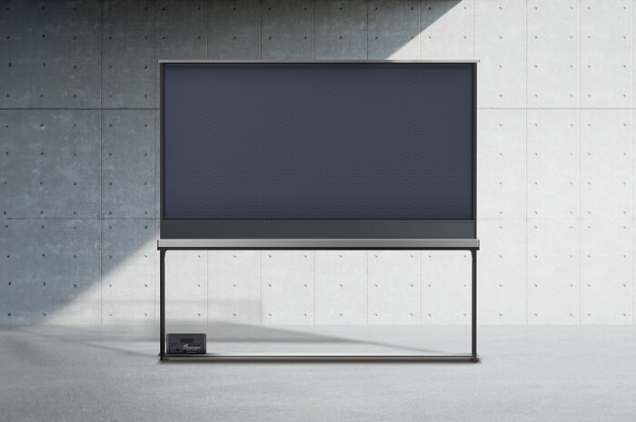 Rear view of LG SIGNATURE OLED T with the shade drawn up to show the black backdrop and the back of a Zero Connect Box.