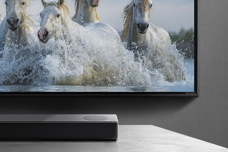 A TV in a stark white room displays colorful spiral shape on the screen.