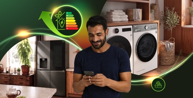 Egy férfi okostelefont használ egy modern mosókonyhában, LG mosógéppel, szárítógéppel és hűtőszekrénnyel, körülötte ragyogó energiahatékonysági grafikákkal.