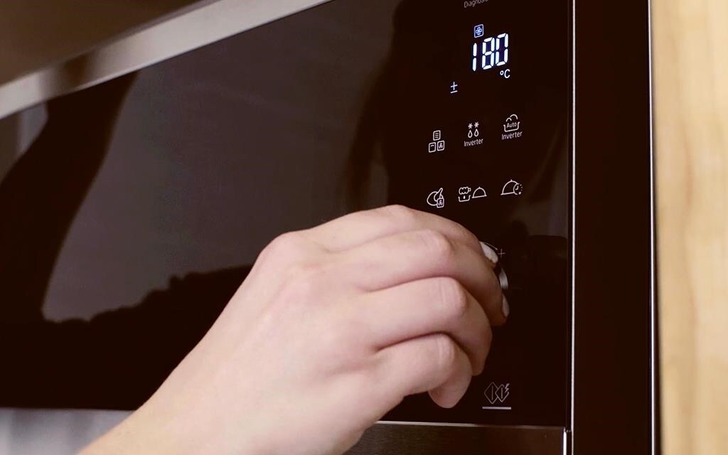 Pumpkin spice is poured into the butter to create pumpkin spiced cinnamon rolls in the LG NeoChef Countertop Microwave Oven