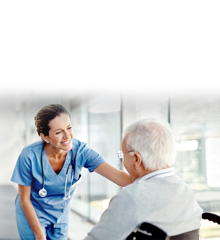 Gambar seorang perawat yang sedang tersenyum kepada pasien.