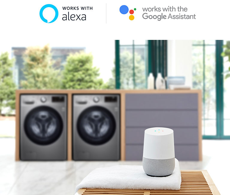Dua mesin cuci LG di belakang Google Home dan rak handuk, dengan logo Alexa dan Google Assistant di atasnya.