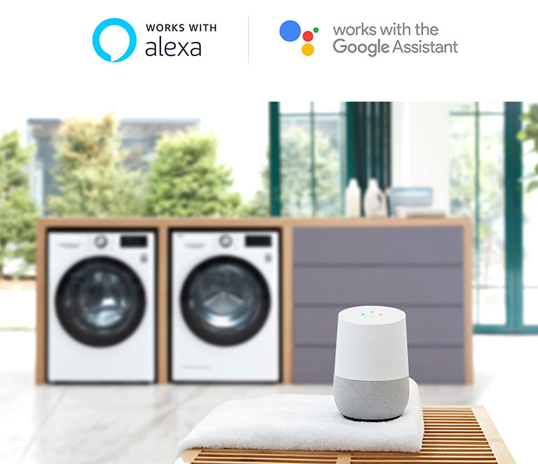Dua mesin cuci di belakang meja dengan Google Home di atas handuk putih, serta logo Alexa dan Google Assistant di atas.