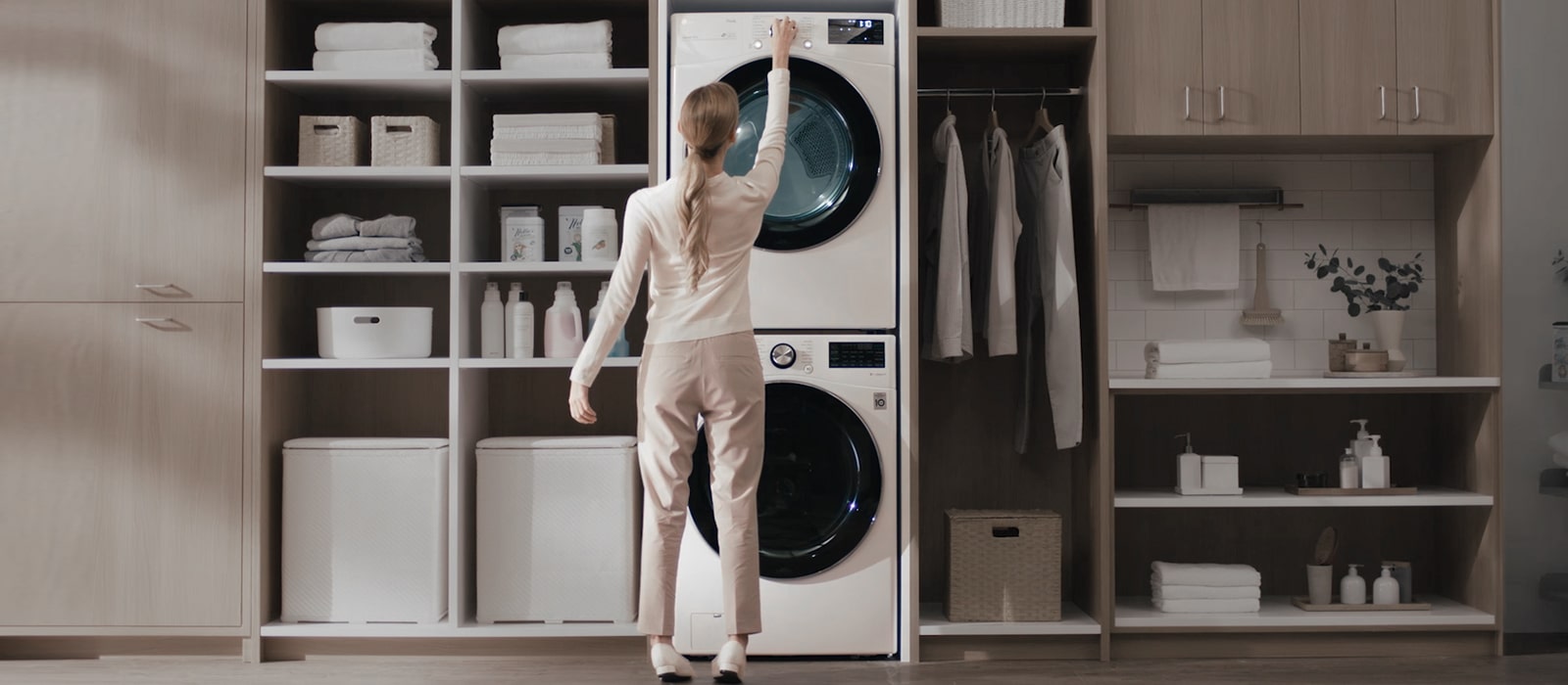 A woman is manipulating the panel at the top of the product with her arms raised.