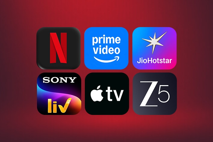 The Netflix, Prime Video, Disney+, and Apple TV app logos stand side-by-side in front of a blue backdrop. 