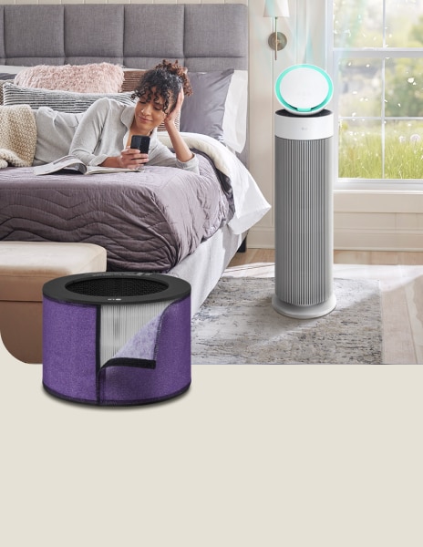 LG air purifier with an allergen filter running next to a bed, as a woman reads a book nearby.