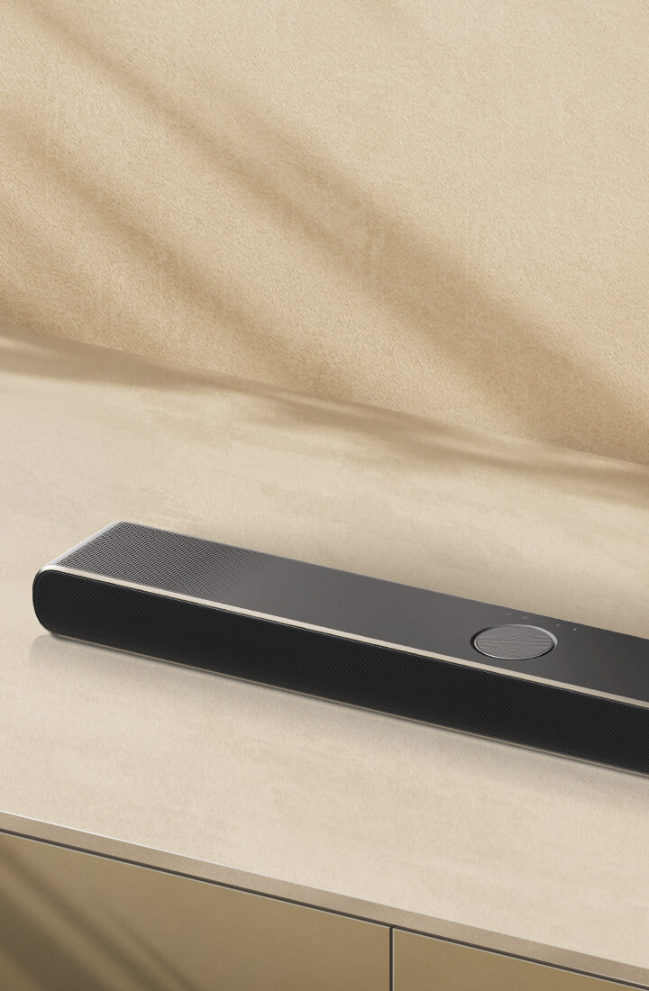 LG Soundbar on a beige surface against a beige backdrop in angled aerial perspective. 