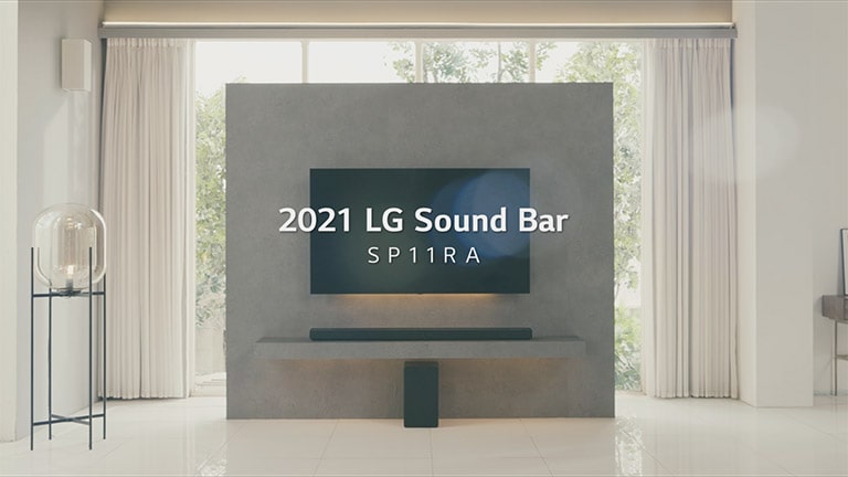 A sound bar and a subwoofer are placed in a wide, bright living room. Click to watch the SP11RA product video (video)